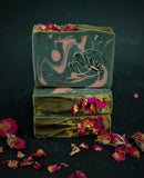 Black soap with rose clay swirl and dried rose petals on top