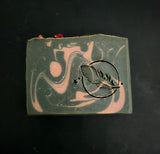 Black soap with rose clay swirl and dried rose petals on top