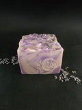 Purple swirled soap scented in lavender and chamomile topped with glitter and dried lavender buds