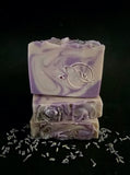 Purple swirled soap scented in lavender and chamomile topped with glitter and dried lavender buds