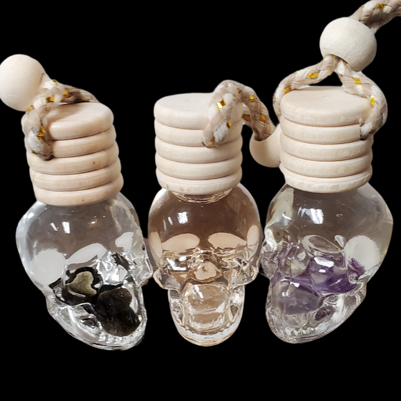 Skull scent diffuser with natural wood diffuser lid and tan string with natural wooden bead.