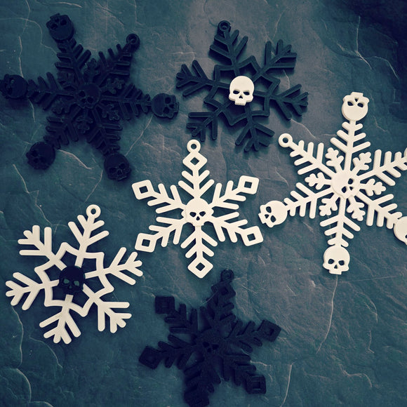 assorted black and white snowflake ornaments with skulls