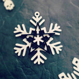 white snowflake ornament with black 5 pointed star