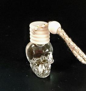 Skull scent diffuser with natural wood diffuser lid and tan string with natural wooden bead.